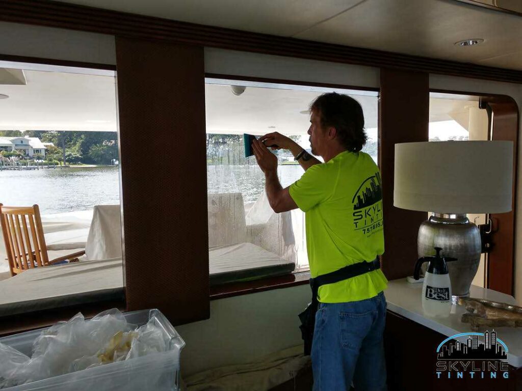installer working on tinting yacht window