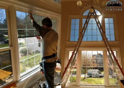 residential window tint being installed by worker