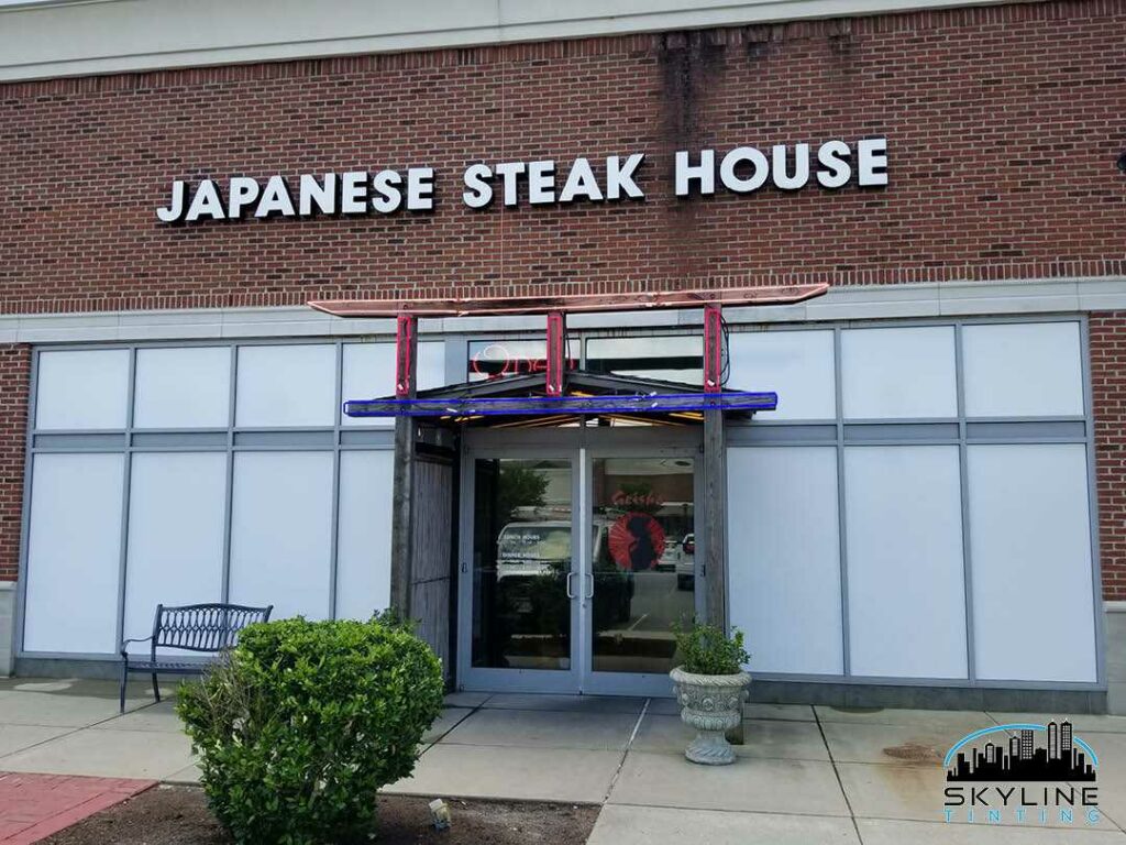 exterior of restaurant with white privacy vinyl installed over windows