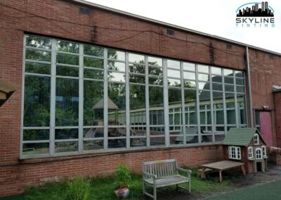 reflective mirror tint installed on windows of a red brick building