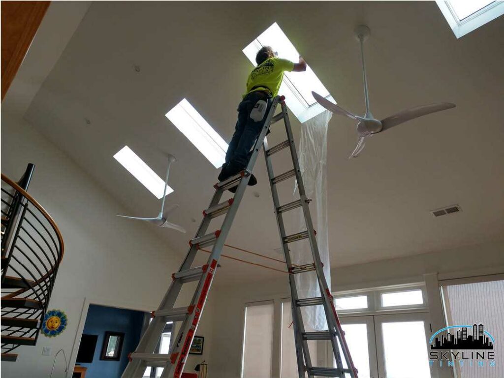 installer working on skylight tint with tall ladder