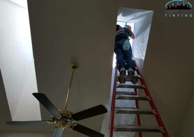installer up into a skylight tunnel installing tint