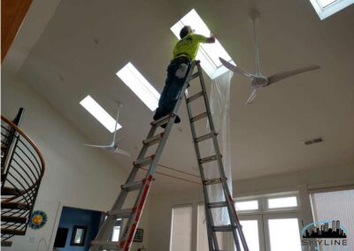 installer working on skylight tint with tall ladder