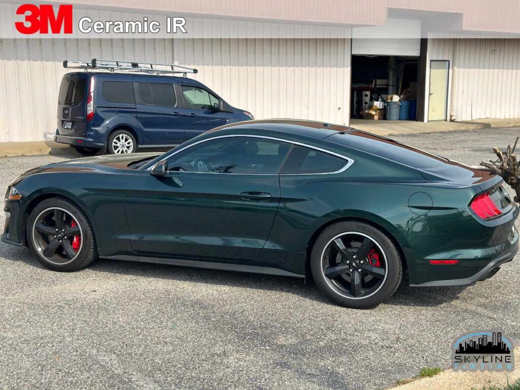 rear 3/4 view of dark green sports car with lightly tinted windows