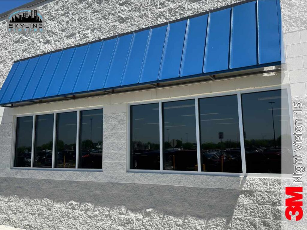 exterior view of commercial building with blue awning with dark tinted windows