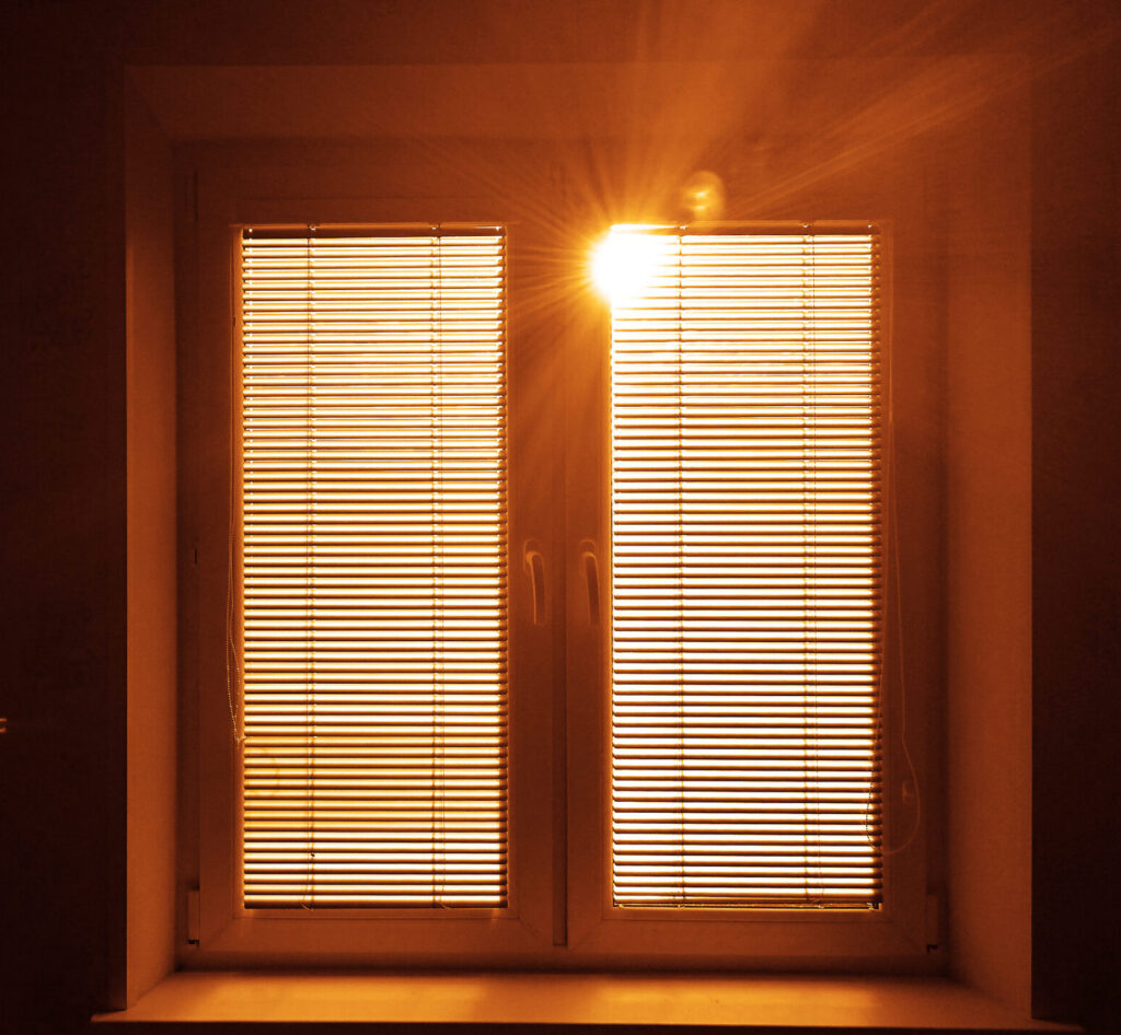 closed-blinds • Skyline Tinting LLC interior view of two doors with closed blinds and bright sun viewable
