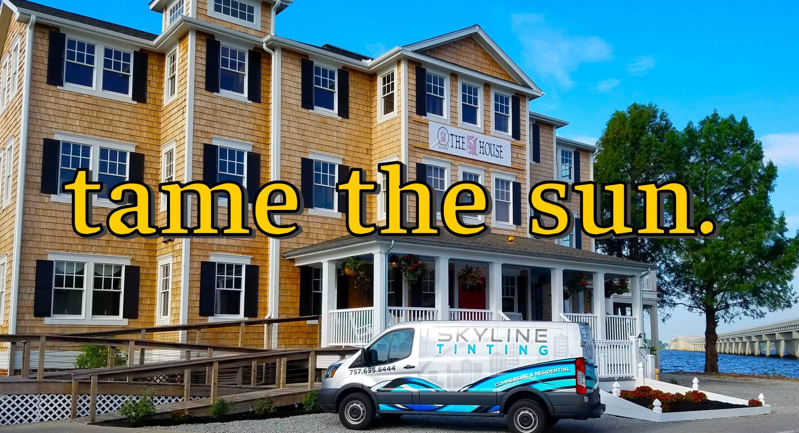 Hotel with tan siding and dark shutters, overlaid with bold yellow text 'tame the sun'; foreground shows a Skyline Tinting van by a waterfront.